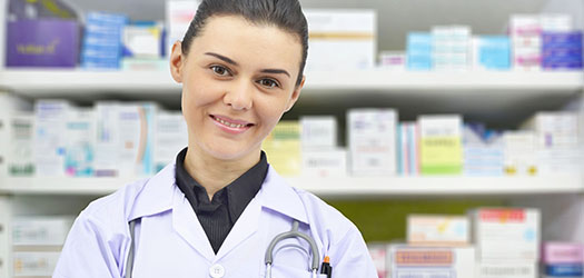 Beautiful young doctor in pharmacy drugstore.
